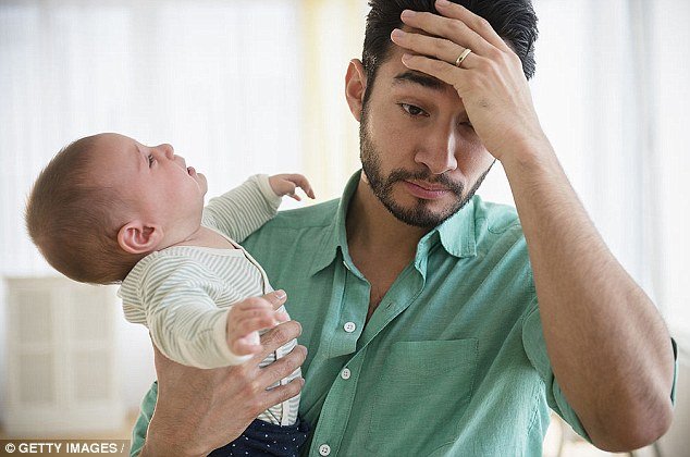 Stressed young father with baby